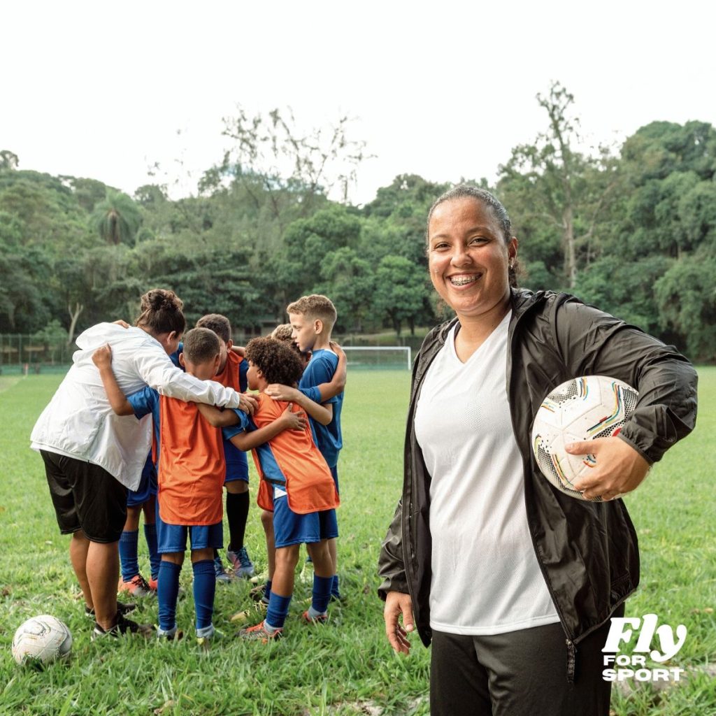 Female coach smiling with youth soccer team